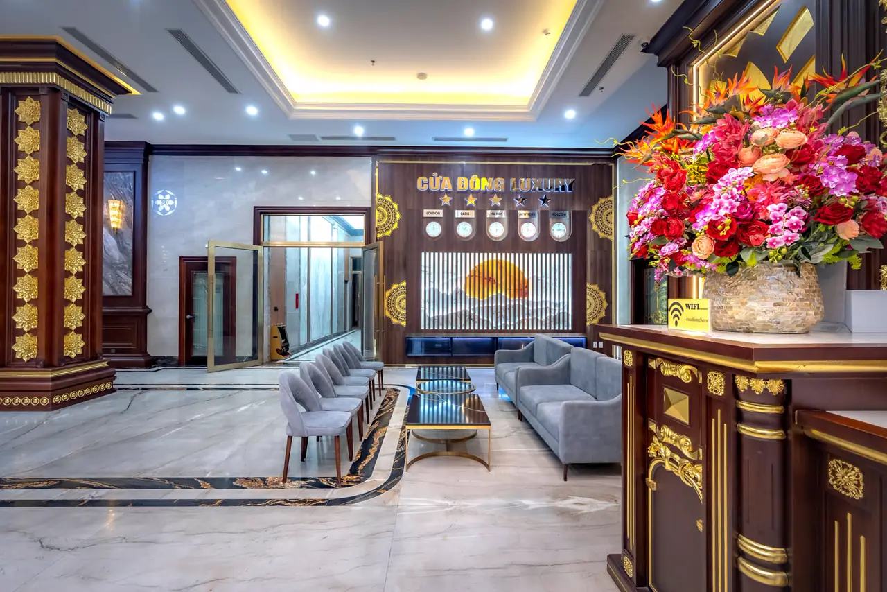 A quiet practice front desk with white orchids and a closed appointment book.